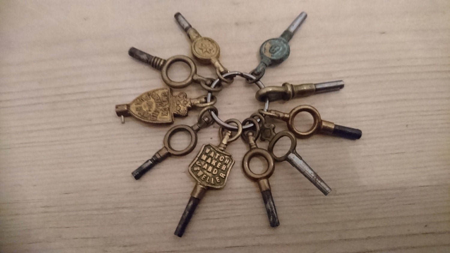 Ten vintage pocket watch keys two advertising jewellers