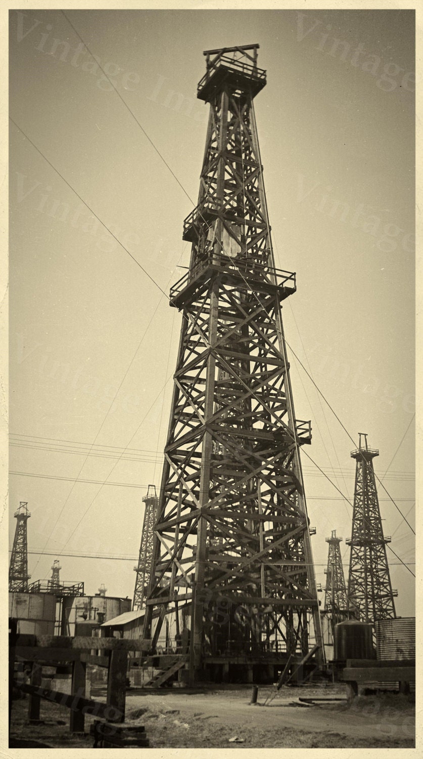 old-historic-oil-well-drill-drilling-rig-derrick-oil-gusher-field-sepia