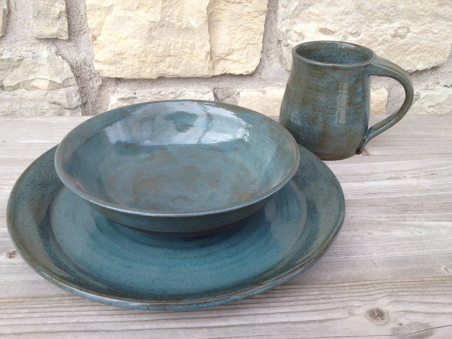 4pc place setting Pottery Dinnerware Teal on dark brown clay