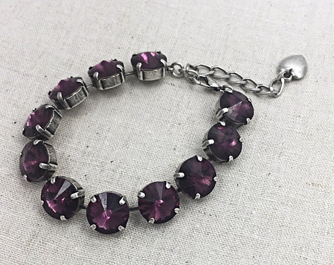 Stunning statement bracelet adorned with colorful purple amethyst Swarovski crystals that provide plenty of eye-catching sparkle.