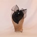 Handmade black heart shaped hat decorated with diamanté details