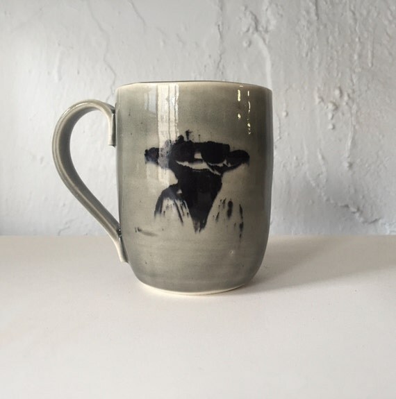 Handmade grey ceramic yoda themed mug.