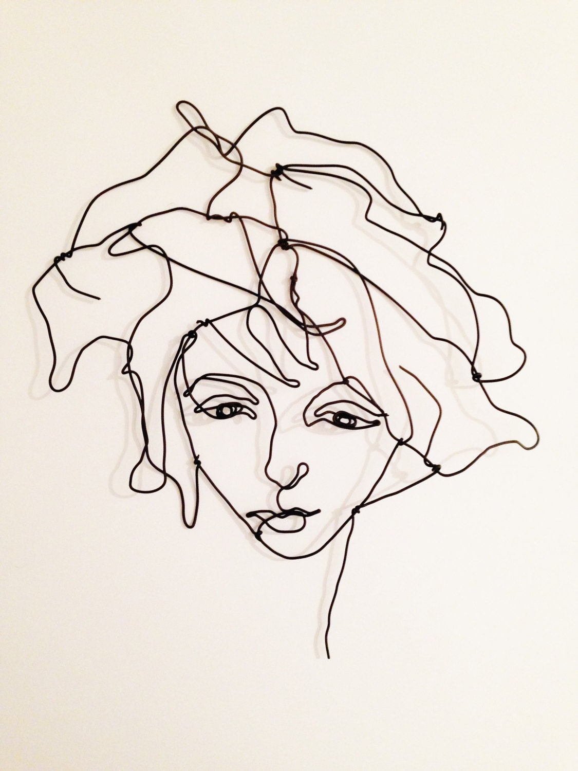 Wire wall art Portrait of a girl with forelock and wavy