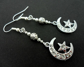 A pair of pretty diamante silver plated moon and star dangly earrings.