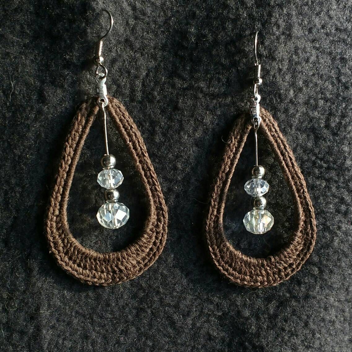 Brown crocheted teardrop earrings with crystal accent.