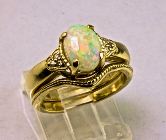 Antique style Opal Engagement ring with Diamond accents.