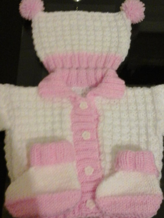 White and pink knitted jacket with tea bag hat by Pollysbabyknits