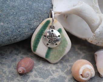 Tumbled pottery with sand dollar charm