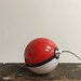 Hand-made Pokeball Themed Battery Pack / Phone Charger / Power bank (attaches to belt loop or backpack with a keychain clasp)