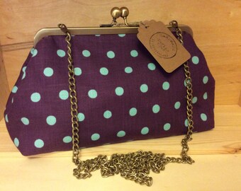 navy and white polka dot clutch bag