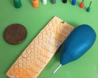 Polymer clay circle cutters with texture needle tool.