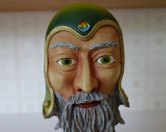 A wizard mask his beard makes the stand