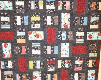 Quilted wall hanging or lap quilt. Pirates, Pirates, Pirates. Machine pieced and quilted