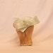 Handmade pale green ladies occasion hat, decorated with bow, delicate feathers & beading