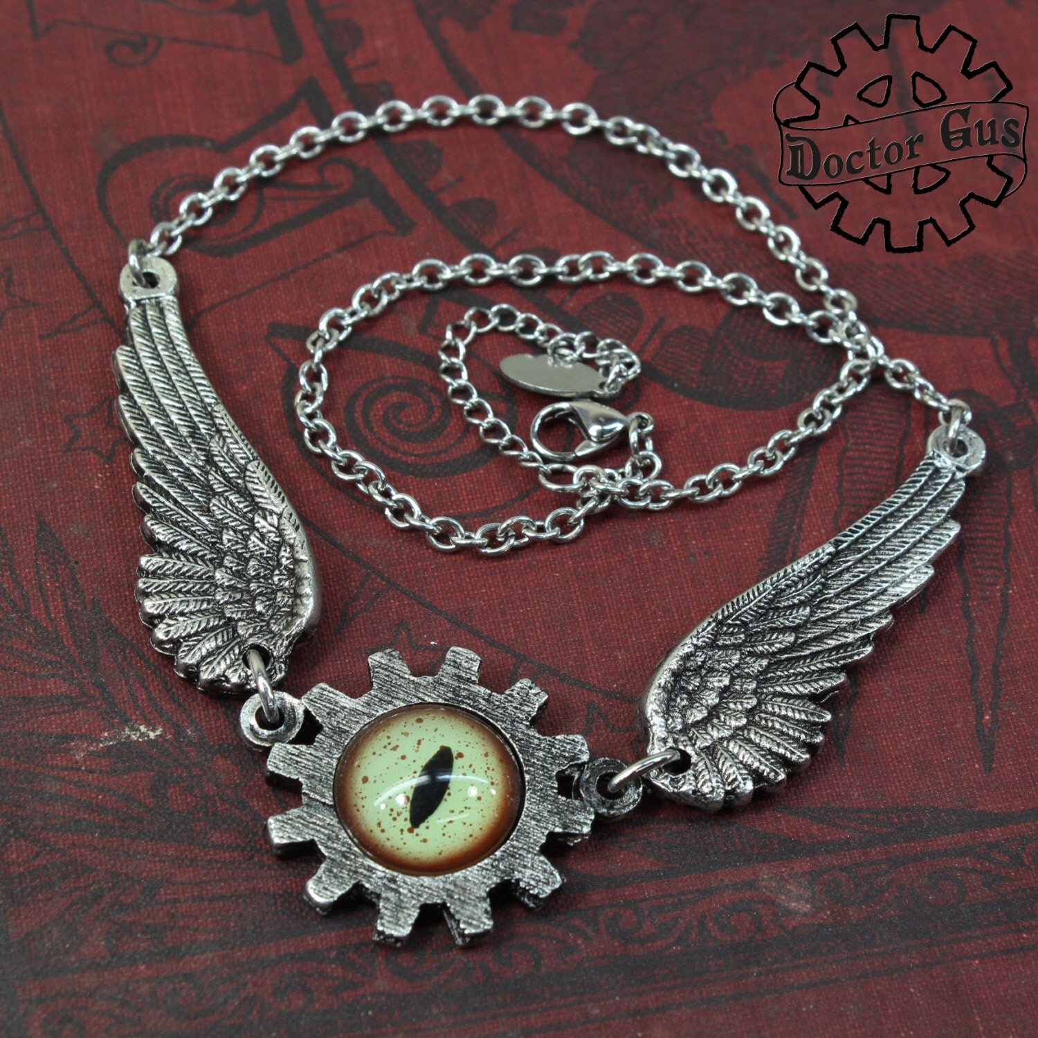 Winged Mechanical Eye Pendant With Green Glass Alligator Eye