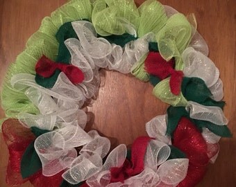 This is italian wreath made of red white & green deco mesh also there are some burlap bows that are red,green