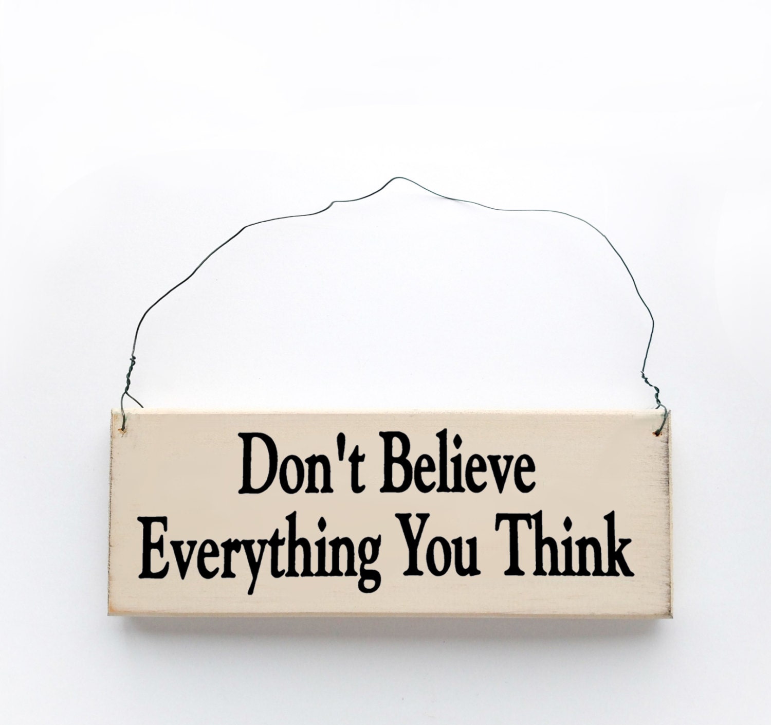 Wood sign saying: Don't Believe Everything You Think