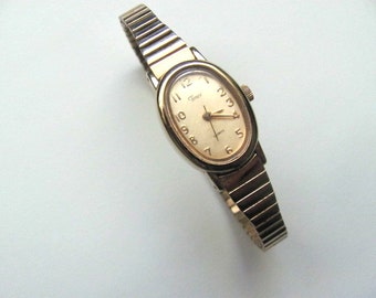 Vintage women's Timex watch, gold tone, stretch band, bracelet style wrist watch