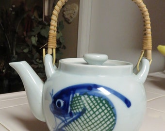 Vintage Asian Glazed Ceramic Tea Pot With Blue Fish Design And Rattan Handle