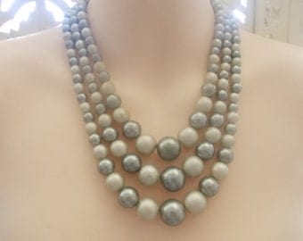 1950s 3 strand graduated bead necklace in two shades of grey will set off a vintage 1950s outfit.