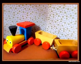Vintage wooden toy train - Steamengine (locomotive) with two wagons made of wood.