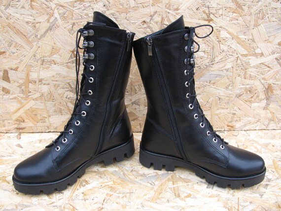 Lace up black leather combat boots with fur for women.