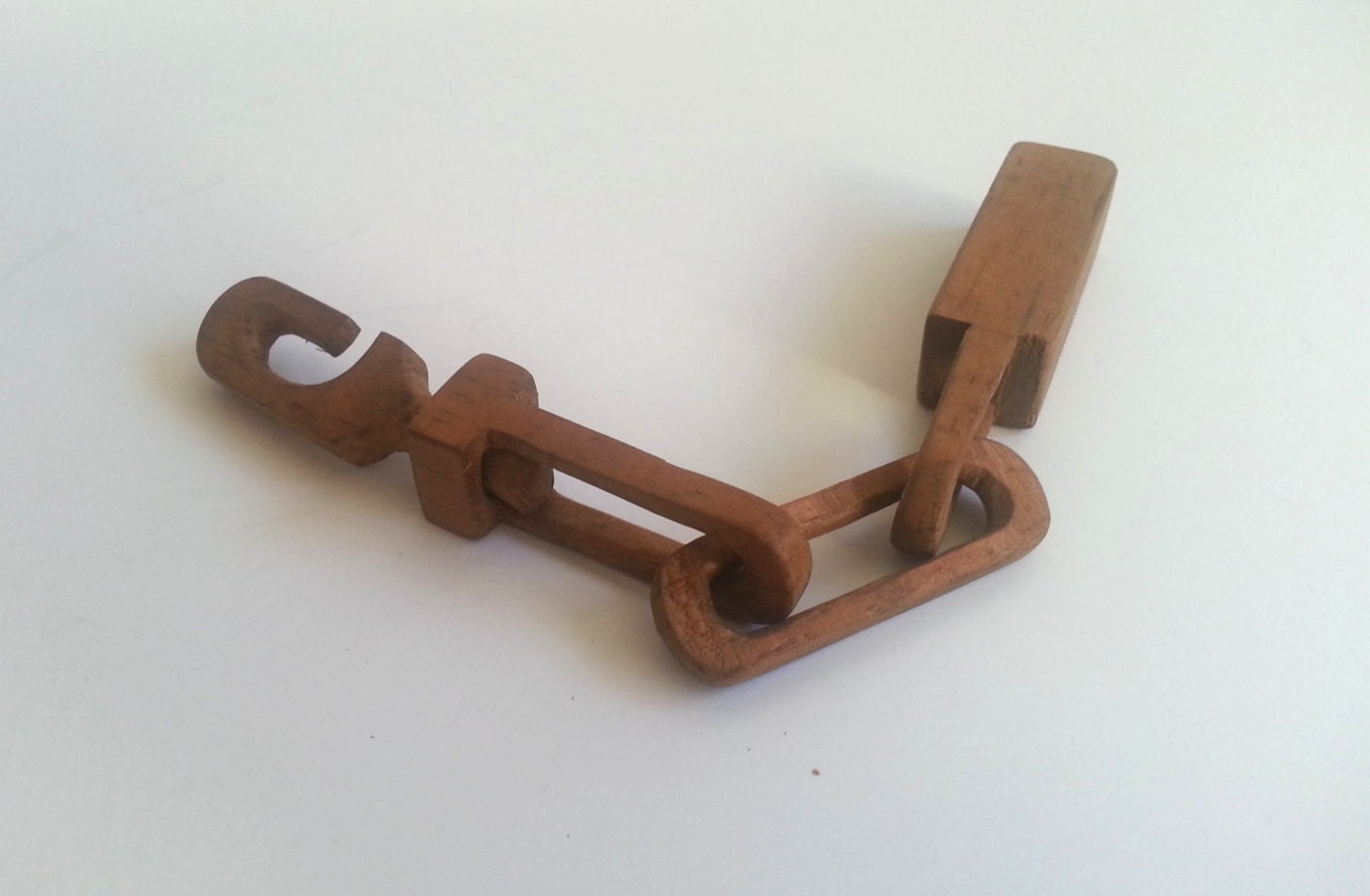 folk art carved wood chain puzzle chain carved wood trick