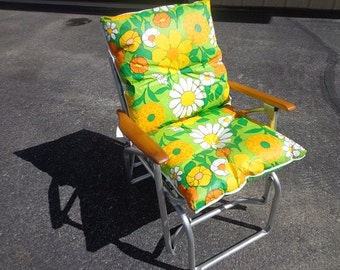 A fantastic 1960s-70s vintage retro Lawn outdoor patio glider rocking chair with the vintage flowered cushion.excellent shape