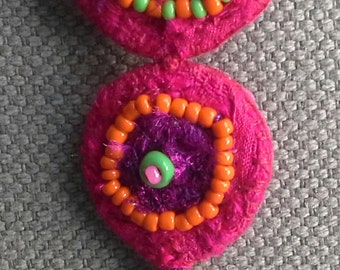 Textile pin/medallions to the colors bright and tonic.