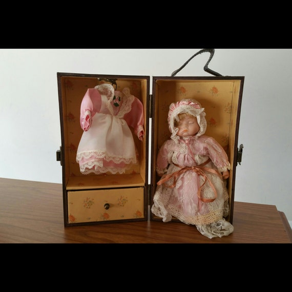 Porcelain baby doll with wooden box