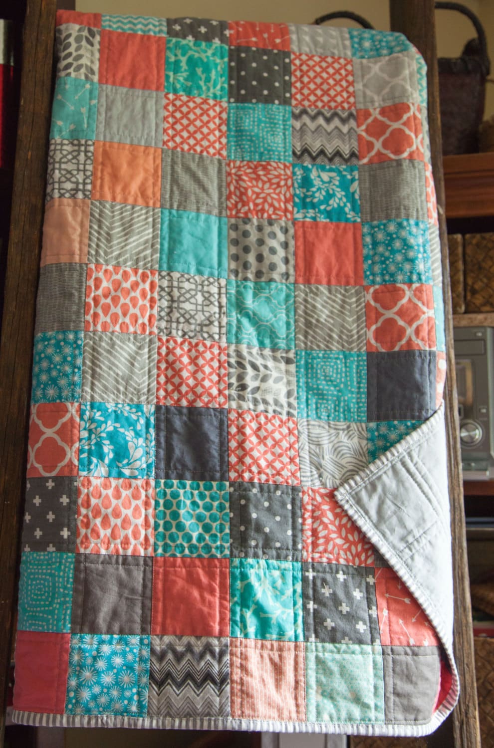 Modern handmade baby patchwork quilt in coral blues and