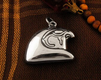 Gleaming silver falcon pendant