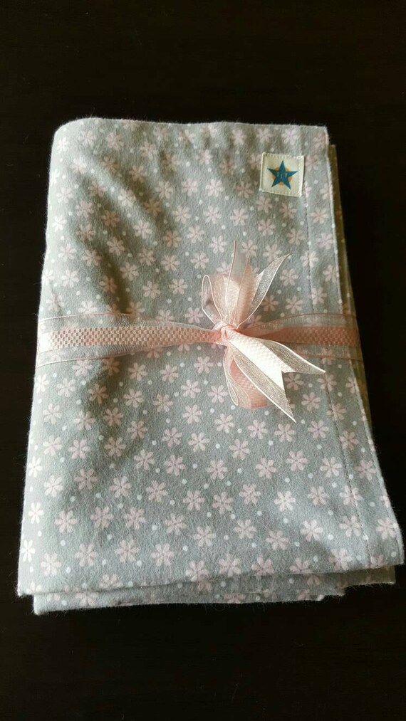 Baby girl swaddling blanket. Pretty pink daisy design on a