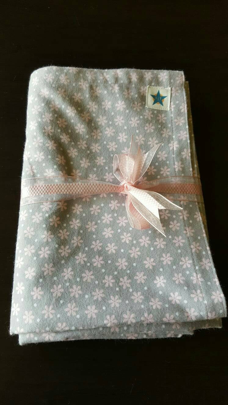 Baby girl swaddling blanket. Pretty pink daisy design on a