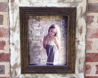 Heavily distressed 11x14 picture frame in white.
