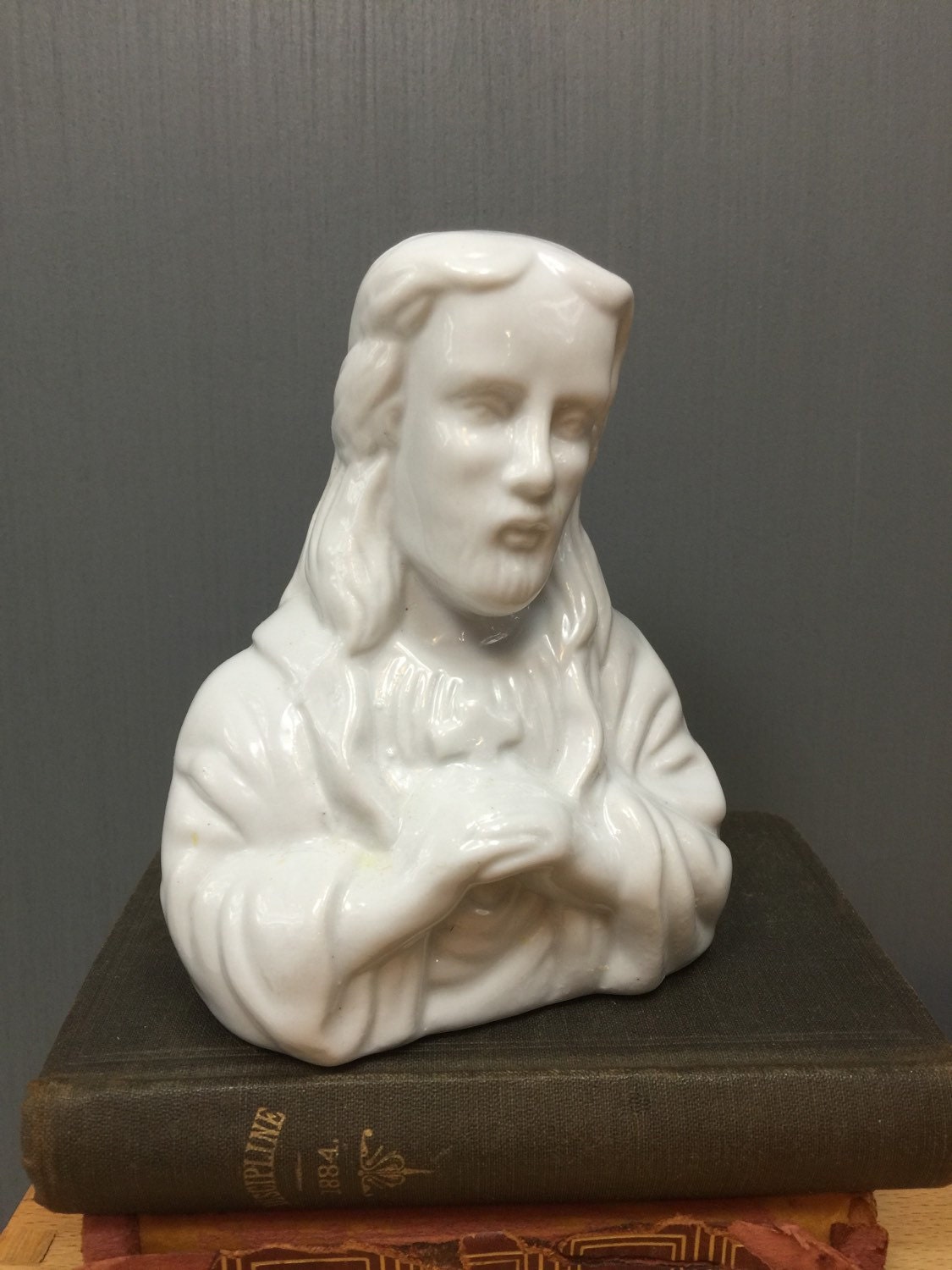 White ceramic Jesus statue. Catholic statuary.