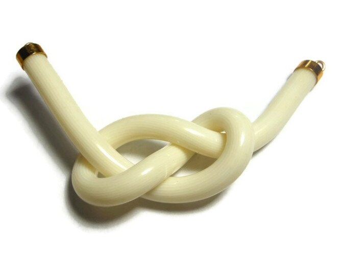 Cream knot focal charm, acrylic and gold-finished, opaque striated , 3" x1" knot, 2 loops, almost instant necklace or get creative