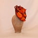 Stunning handmade metallic burnt orange ladies hat decorated with orange orchid flowers handmade in Yorkshire by Jacqueline Walker Millinery Stunning handmade metallic burnt orange ladies hat decorated with orange orchid flowers