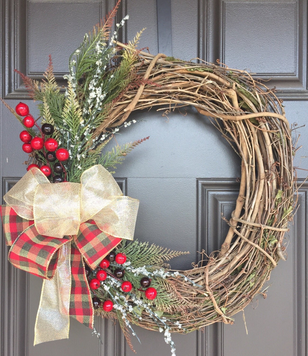 Rustic Christmas wreath with large gold and plaid bow