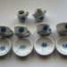 Miniature, Ceramic Tea Set in White with a Blue Floral Pattern. Miniature Cups and Saucers,with a Sugar and Creamer, 4 Mini Cups and Saucers