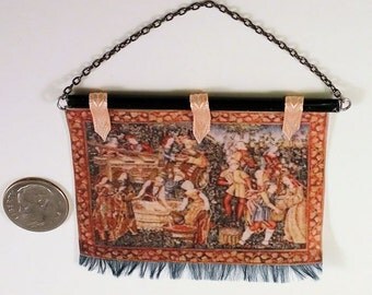 Colorful tapestry of Medieval or Tudor wine making, black rod, green fringe, pale coral ribbon. 1 to 12 scale miniature. Hand made in USA.