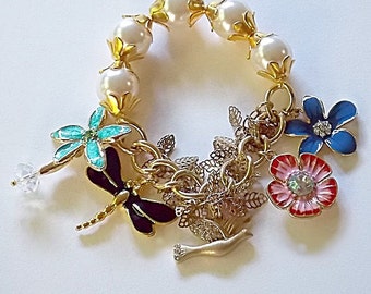 Enamel charm bracelet. Enamel flowers - Dragonfly - Gold bird - Gold leaves - Faux pearls