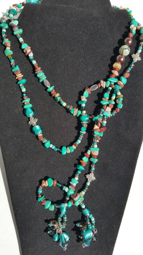 Lariat style long beaded necklace with beaded tassels.