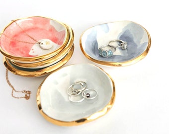 Handmade ceramic ring dish in white with a wash of watercolor glaze adorned with 22K gold edges