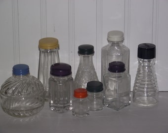 Nine vintage bottles (1950's-1960's) from various products with colorfully painted metal caps, all in very good condition.
