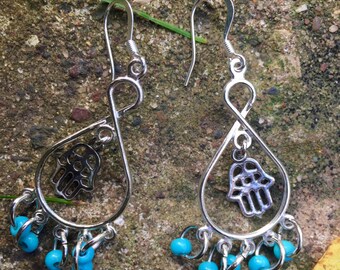 blue glass hamsa hand chandelier earrings