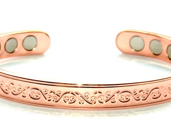 Elegant etched pattern design on a copper bracelet embedded with six magnets