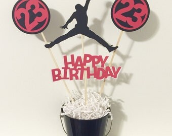Jordan happy birthday centerpiece with 4 Jumpman cutouts.