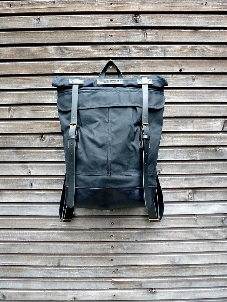 Black waxed canvas backpack with roll to close by treesizeverse