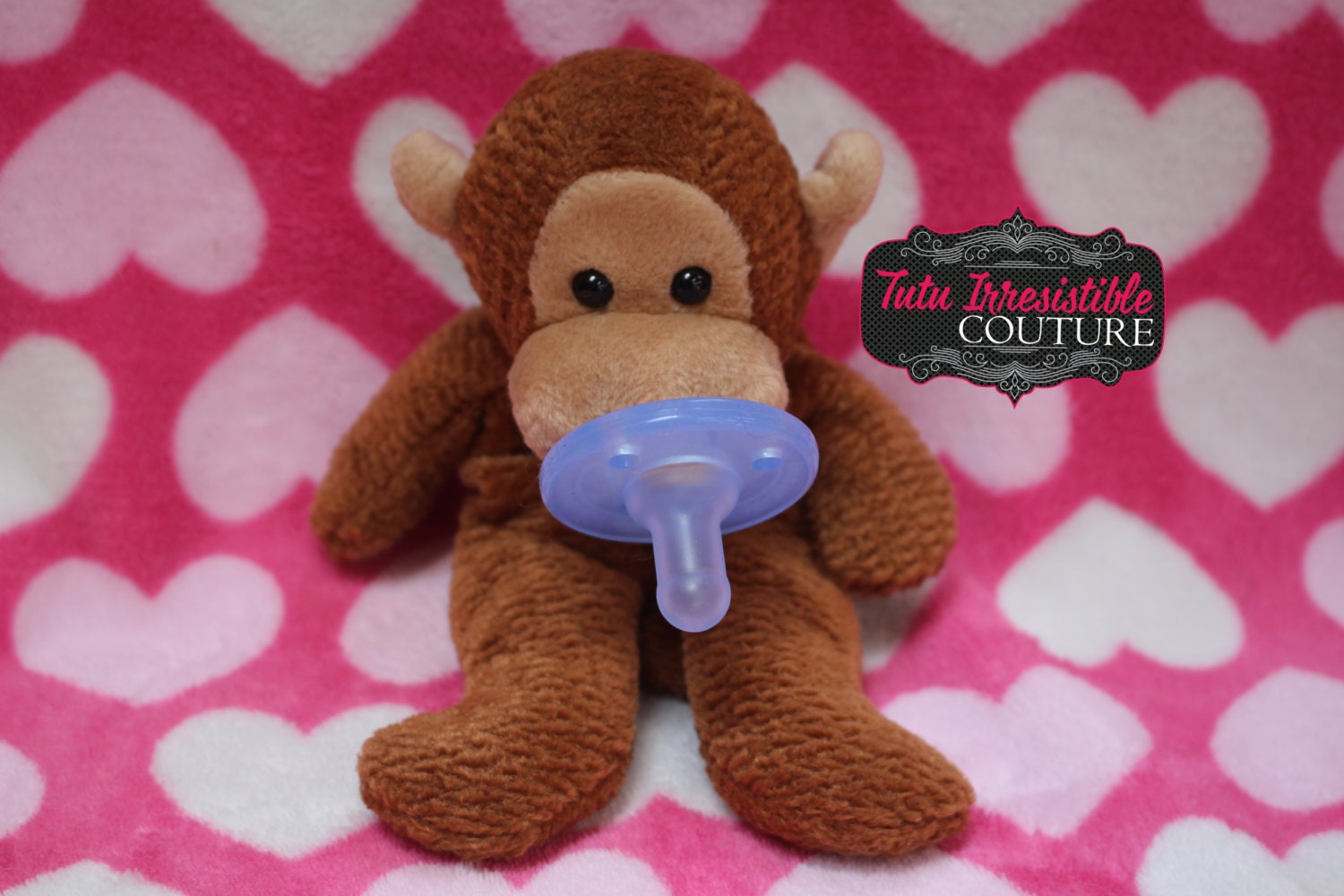 stuffed monkey with pacifier